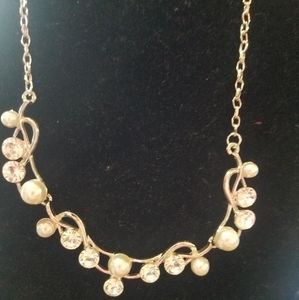 Gold tone necklace with rhinestones.